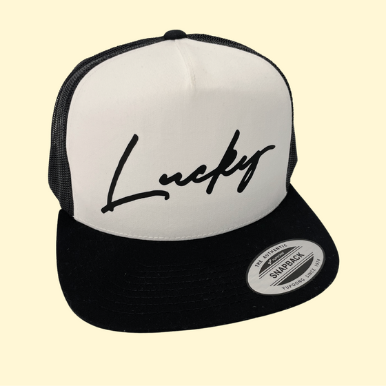 Black LUCKY on a Black and White Trucker Cap
